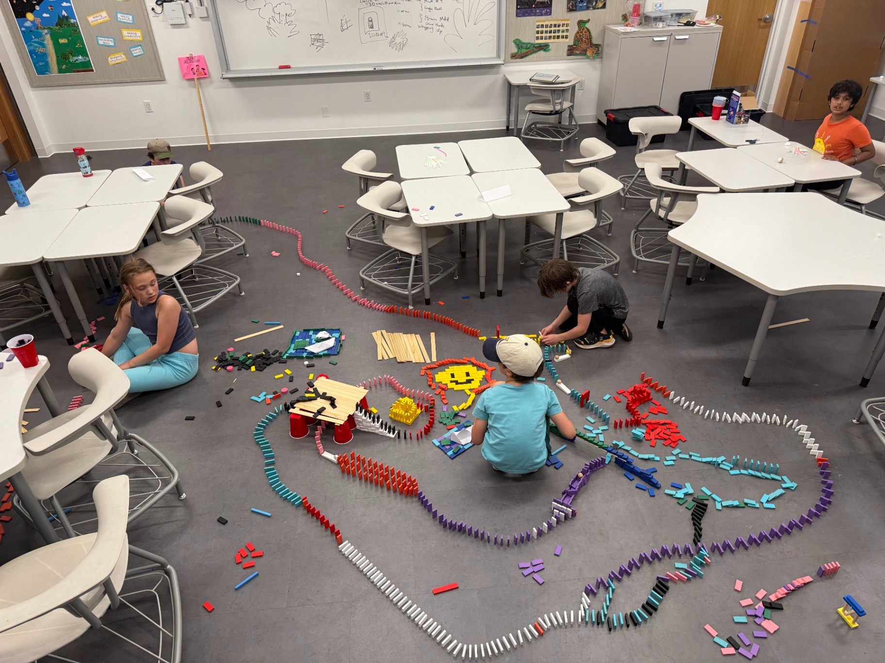 Children building a giant domino run in a Recreation Academy club