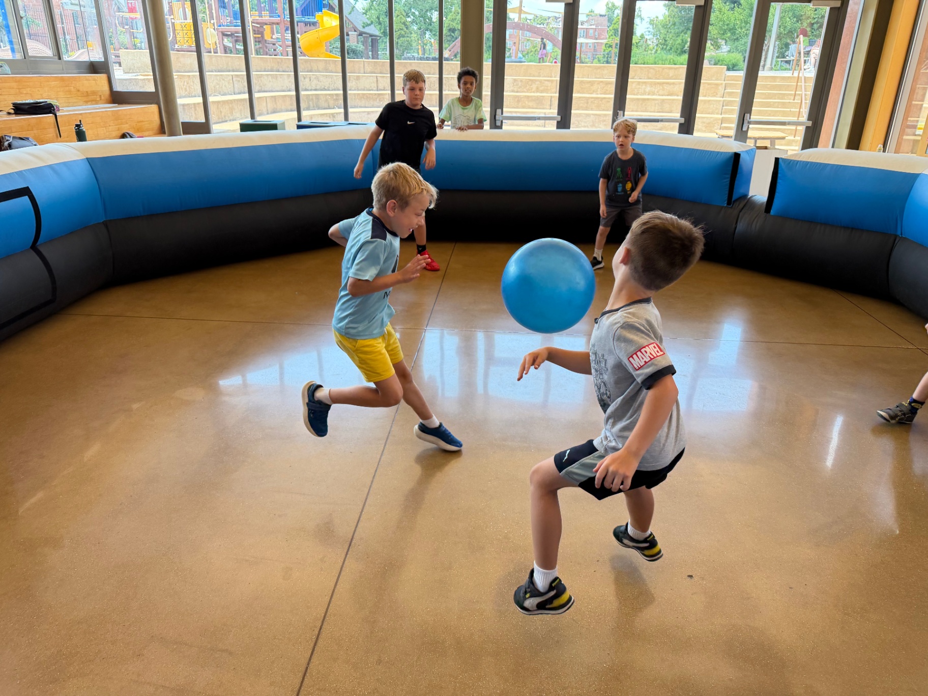 Recreation Academy campers playing ga-ga ball in an inflatable pit