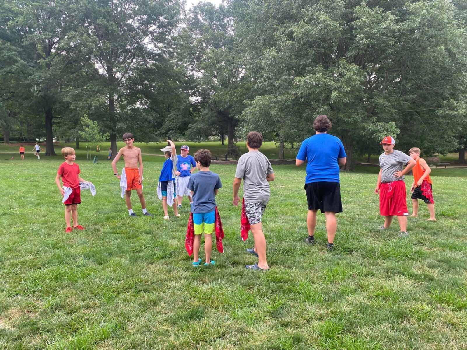 A Recreation Academy instructor leading campers in a field game